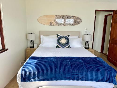 a bedroom with a blue and white bed with two lamps at Blue Water in Southampton