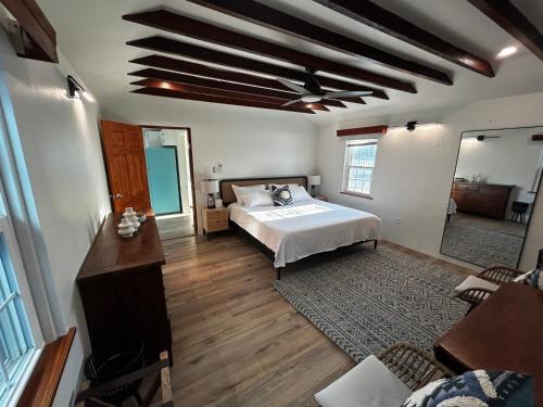 a bedroom with a bed and a ceiling fan at Blue Water in Southampton