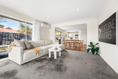 a living room with a white couch and a table at SAUNA & ICE BATH! - Your Health Retreat Escape in Capel Sound