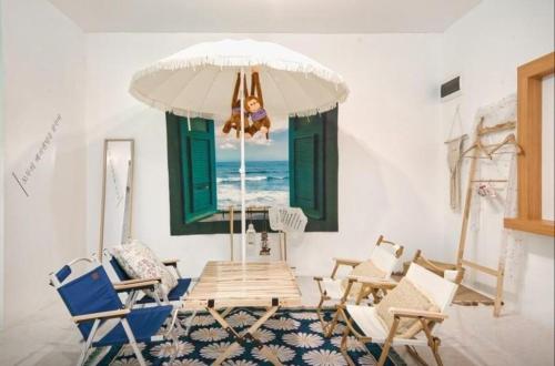 a room with chairs and a table and a window at Jeryeong Forest Pension in Gapyeong