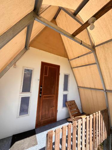 a front door of a house with a porch at Dieng glamping syari'ah in Dieng
