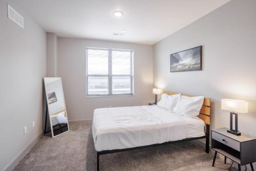 a bedroom with a bed and a window at TWO CozySuites at the Banks with Pool 18 in Cincinnati