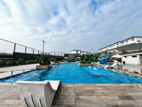 a large swimming pool with chairs and a slide at Casa de Lujo, Parking, Piscina, Gym, Juegos in Guayaquil
