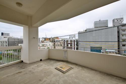 an empty balcony with a view of a city at cuculu MAEJIMA 4F in Tomari