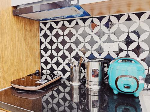a kitchen counter with a coffee maker and a toaster at Soin Westlake Apartment in Hanoi