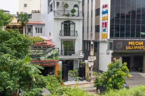 a city street with tall buildings and trees at The Dahlia Hotel & Apartments in Hanoi