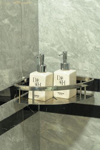 two complimentary toothbrushes sitting on a glass shelf at The Dahlia Hotel & Apartments in Hanoi