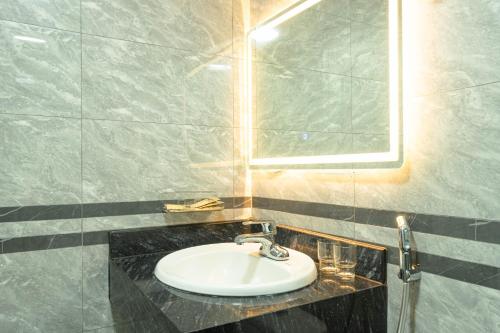 a bathroom with a sink and a mirror at The Dahlia Hotel & Apartments in Hanoi