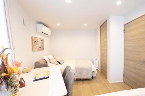 a bedroom with a bed and a living room at ZAITO Waseda Terra Hotel in Tokyo