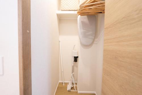 a small hallway with a door to a room at ZAITO Waseda Terra Hotel in Tokyo