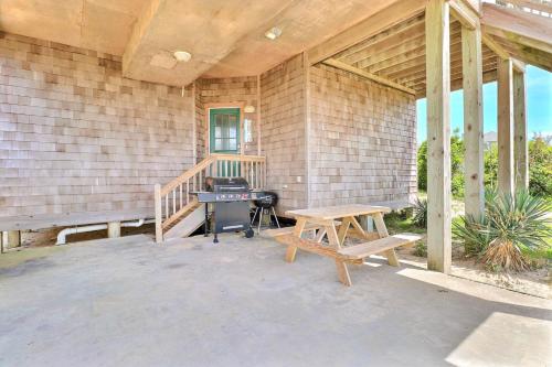 a patio with a picnic table and a bench at 7076 - JMJ Seascape in Nags Head