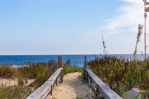 a wooden path to the beach with the ocean in the background at 7076 - JMJ Seascape in Nags Head