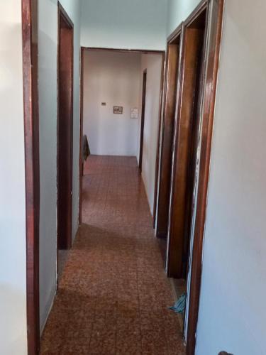 a long hallway with doors and a long hallwayngth at Cantar do passaro in Jaboticabal