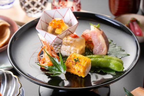 a plate of food with sushi on a table at Oni no Sumika in Izu