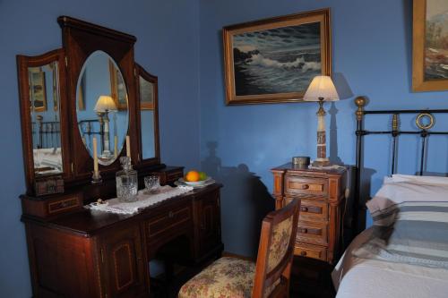 a bedroom with a bed and a dresser and a mirror at Boutique Hotel Premium Vendimia in Santa Cruz