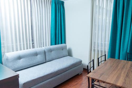a living room with a couch and a table at Departamentos Amoblados Torre Tagle in Santiago