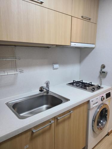 a kitchen with a sink and a stove at Hotel Modak Namdaemun in Seoul