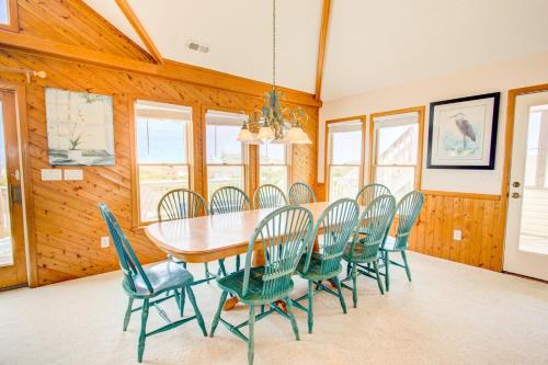 a dining room with a table and chairs at 3035 - Morning View in Southern Shores