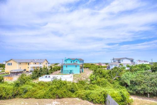 a row of houses on a hill with trees at 3035 - Morning View in Southern Shores