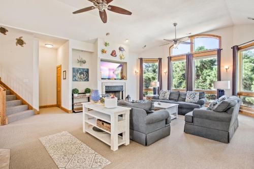 a living room with couches and a ceiling fan at 3050 - Whispering Pines in Southern Shores