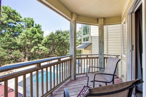 a balcony with two chairs and a view of the water at 3050 - Whispering Pines in Southern Shores
