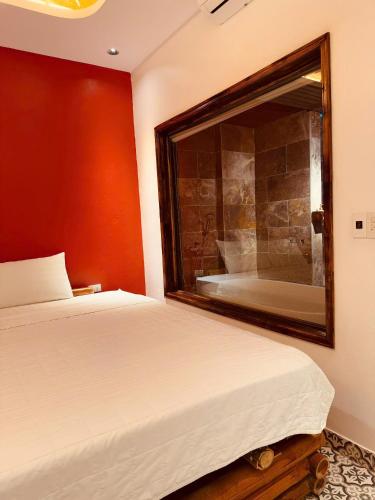 a bedroom with a bed and a large mirror at Tam Coc Golden Fields in Ninh Binh