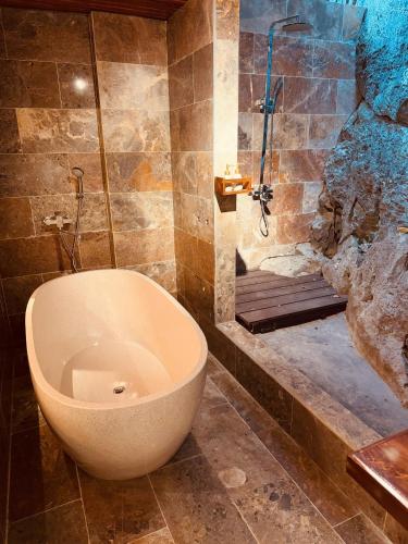 a bathroom with a bath tub and a shower at Tam Coc Golden Fields in Ninh Binh