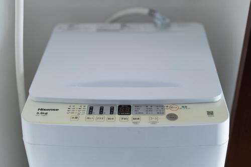 a white dishwasher with its door open with its control panel at Yoshidokulnn7吉德家庭旅馆7 Near USJ Universal Studios Ocean Food Osaka Castle Park Soraniwa Sauce Hot Spring関西スーパ前独棟-近UsJ-空庭菓匠溫泉-海游館-大阪城公園關西空港直達 in Osaka