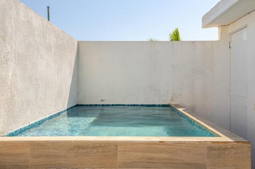 a small swimming pool in a concrete wall at Spacious house with Acapulco club in Acapulco