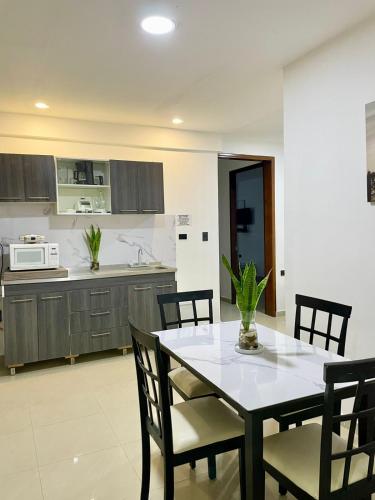 a kitchen with a table and chairs in a kitchen at Apartahotel MKS Caribe in San Andrés