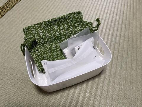 a white container sitting on the floor with a green package at SAMURAI Base in Hakone