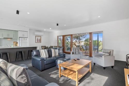 a living room with a couch and a table at Bungala Cottage 28 Jetty Road in Normanville