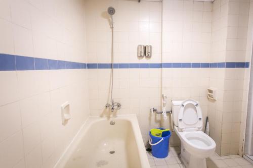 a bathroom with a toilet and a bath tub at Bayu Beach Resort Apartment Seaview Private Beach in Port Dickson