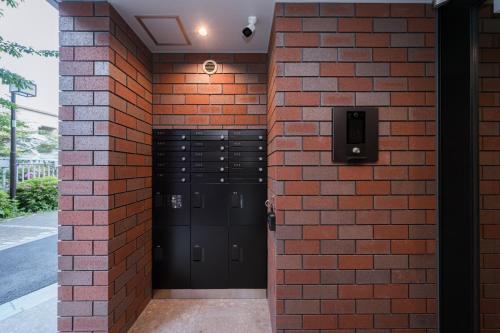 a brick wall with lockers in a building at ZAITO Waseda Terra Hotel in Tokyo