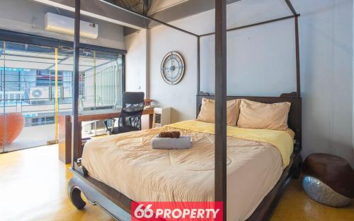 a bedroom with a four poster bed and a desk at Chic Townhouse in Old City in Chiang Mai