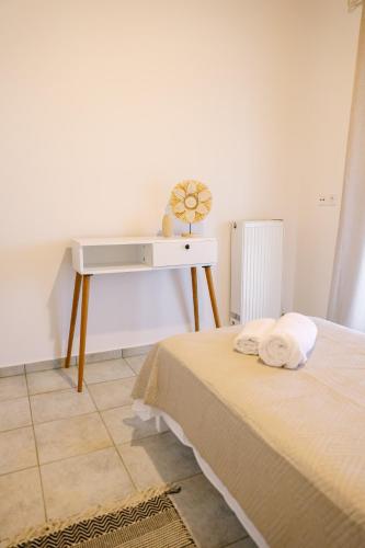 a bedroom with a bed and a desk at EftychiaHouse in Pýrgos