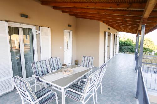 a white table and chairs on a patio at EftychiaHouse in Pýrgos