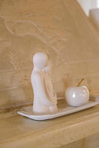 a figurine of two people and an apple on a plate at EftychiaHouse in Pýrgos