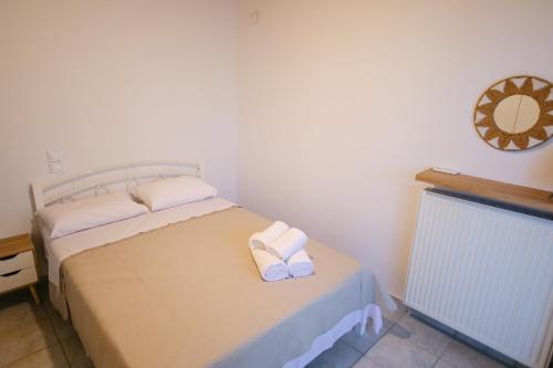 a bedroom with a bed with two towels on it at EftychiaHouse in Pýrgos