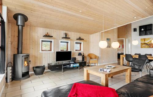 a living room with a couch and a fireplace at Amazing Home In Henne With Sauna in Henne Strand