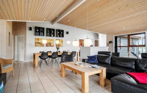 a living room with a couch and a table at Amazing Home In Henne With Sauna in Henne Strand