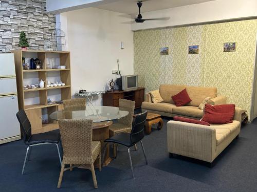 a living room with a table and a couch at Vintage Inn Jonker Walk Melaka in Melaka
