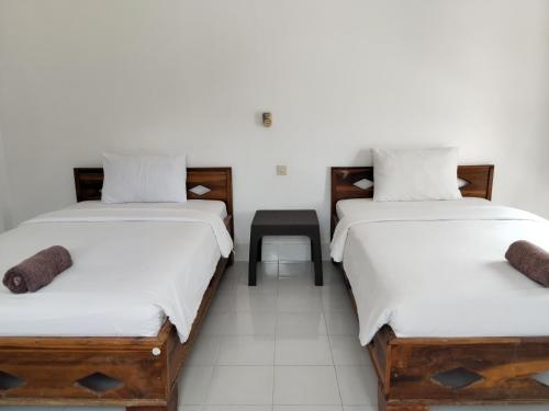 two beds sitting next to each other in a room at Spear Villa in Bumbang