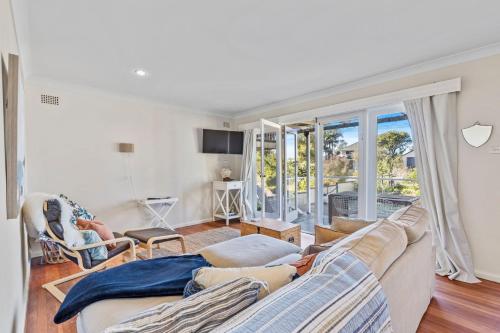 a living room with a couch and a large window at Seahaven at Mossy in Mossy Point
