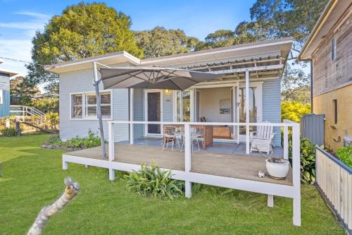 a house with a deck with an umbrella at Seahaven at Mossy in Mossy Point