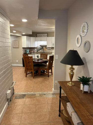 a dining room and kitchen with a table and chairs at Pepper Bungalow in Mesa