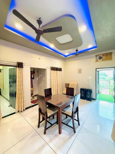 a dining room with a ceiling with blue lights at Vrinda's Villa in Maheshwar