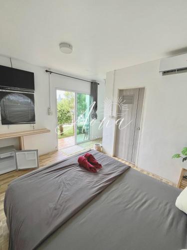 a bedroom with a large bed with red pillows on it at Aona Resort Kohlarn in Ko Larn