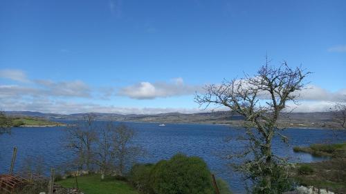a view of a lake with a boat in the water at New Riyork Sweet Home in Geres