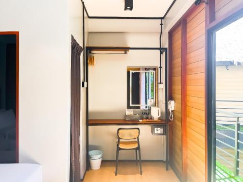 a room with a desk with a computer on it at A Coral Reefs Resort Langkawi by Manhattan Group in Pulau Chupak